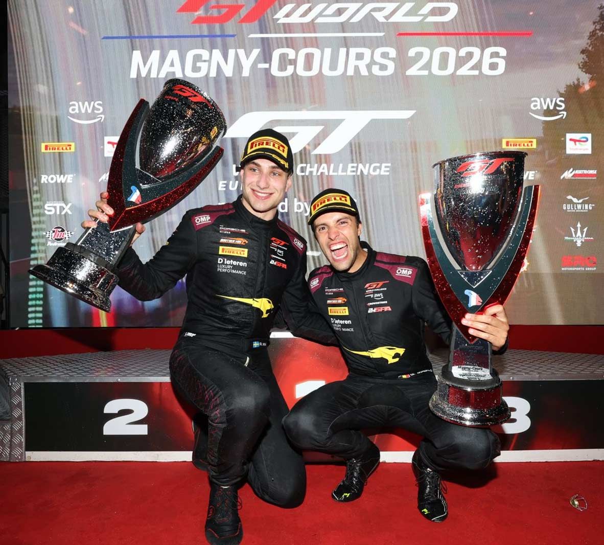 Two drivers holding trophies on the GT World Challenge Europe podium at Magny-Cours 2026